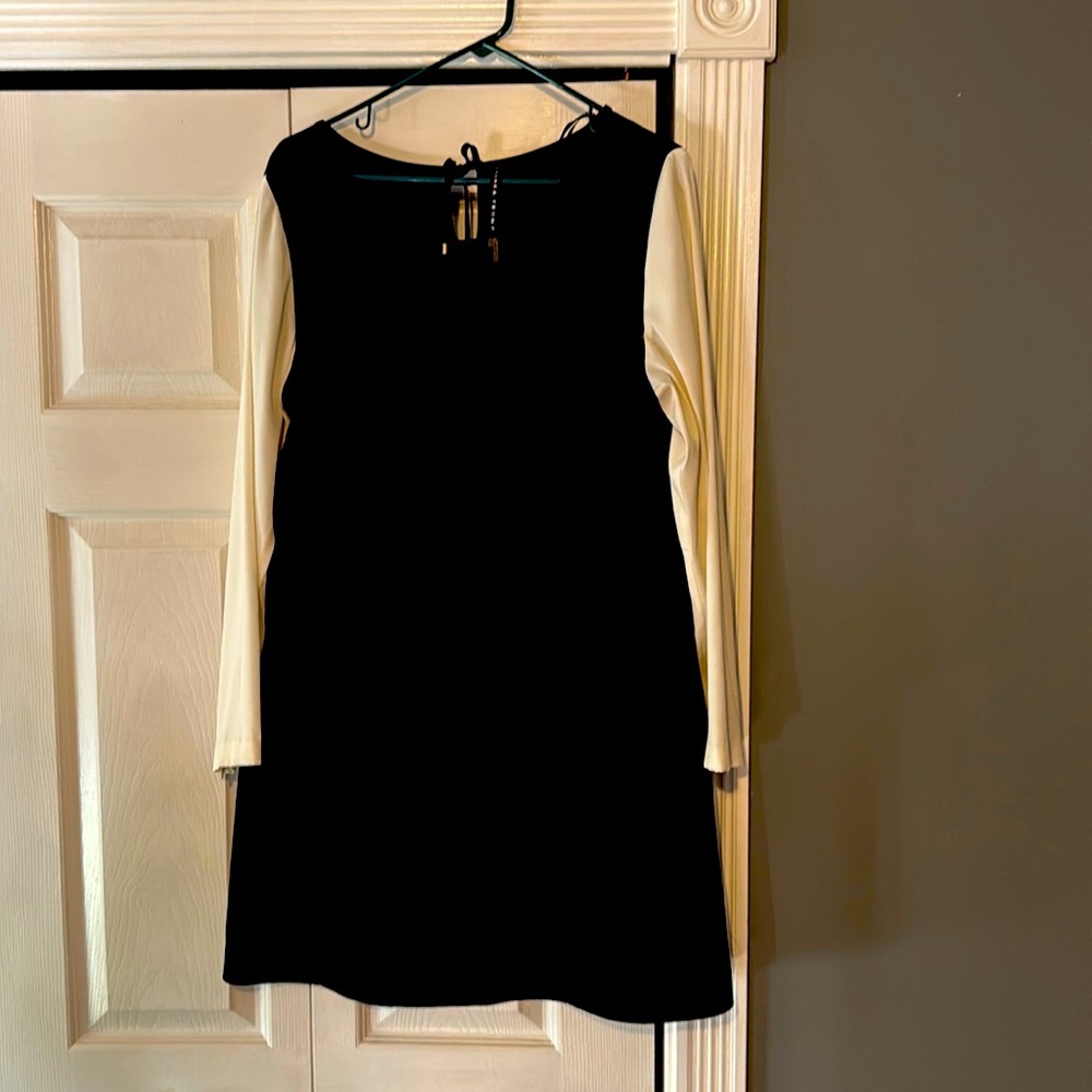Ivanka Trump black short dress with white sleeves.
